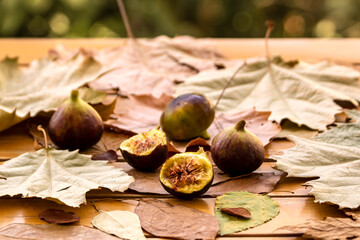 Figs and autumn leaves on the table  