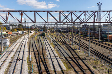 Electric trains are at the railway station in summer day