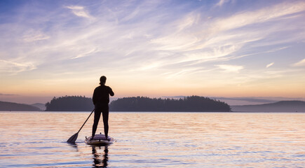 Adventurous Caucasian Adult Woman on a Stand Up Paddle Board is paddling on the West Coast of Pacific Ocean. Sunny Sunrise Sky Art Render. Victoria, Vancouver Island, BC, Canada.
