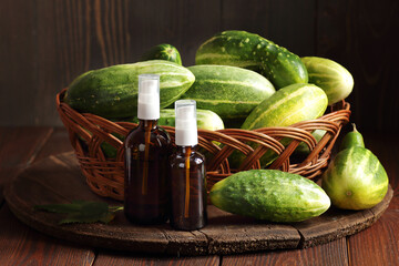 Cucumber seed oil or juice, amber glass bottle with natural extract, closeup, natural medicine and...