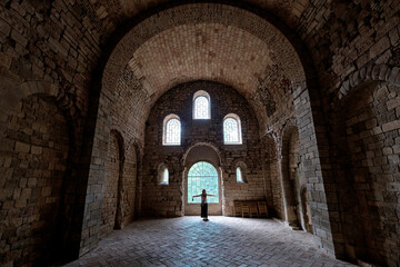 Fototapeta na wymiar San Juan de la Peña, Aragon September 7, 2021, tourist inside the arched interior of the monastery of San Juan de la Peña, a Romanesque work in Huesca.