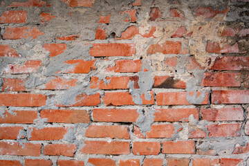 Photo of a brick wall, with an influx of cement mortar and uneven brickwork. Photos for advertising and use in illustration. 