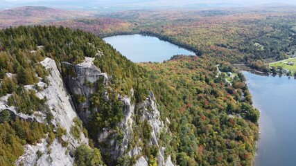 Aerial footage of a mountain with a lake (Mont Pinacle - Quebec)