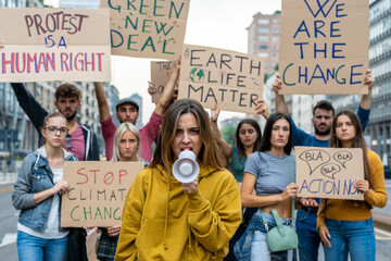 Group of activist people making protest about climate change, public demonstration on the street against global warming and pollution, anger crowd - obrazy, fototapety, plakaty