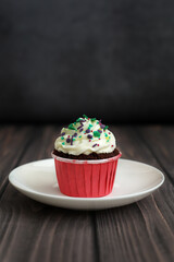 Cupcake with New Years decor on a dark background. Concept food, holidays, happy new year