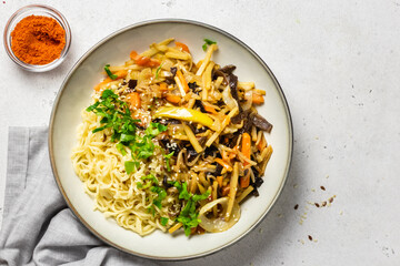 Asian stir fry vegetables noodles in a bowl. Top view, copy space.