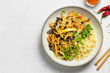 Vegetable stir fry with ginger and garlic, noodles in a bowl. Top view, copy space.