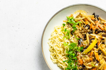 Teriyaki vegetable stir fry, noodles in a bowl. Top view, copy space.