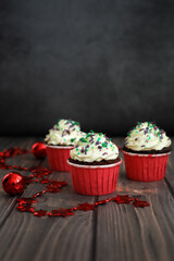 Many cupcakes with New Years decor on a dark background. Concept food, holidays, happy new year.