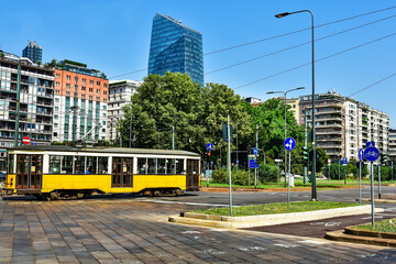 Fototapeta na wymiar Yellow tram on the street in Milan, Italy
