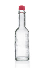Empty glass bottle from hot sauce on white background