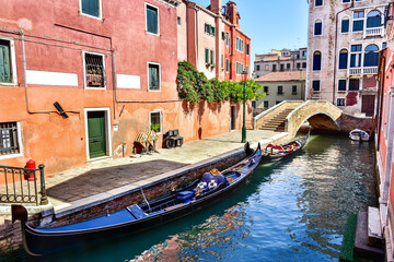 Fototapeta na wymiar Gondola on the canal in Venice, typical Italy architecture