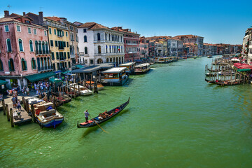 Gondola cruise on the canal in Venice, typical architecture of Italy 