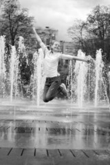 Girl and dry fountain. Childhood. Jump in the fountain, black and white photo.