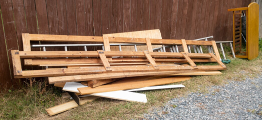 Discarded wood construction frames in alley.