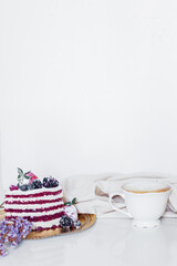Breakfast composition with red velvet cake and a cup of milk and coffee on white background. Flat lay, top view.