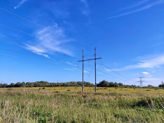 power lines on the field. electricity. power transmission towers