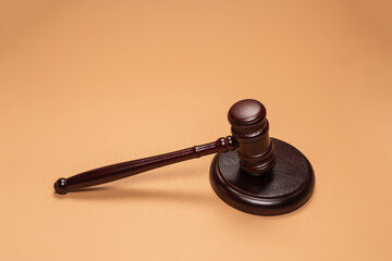 Gavel down on stand on brown background. Justice of law system conceptual.