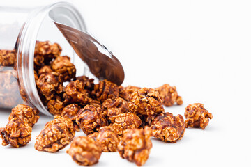 Closeup chocolate coated flavored popcorn on white wooden background with copy space