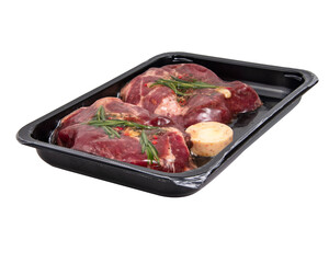 Fresh meat pork steak with garlic, rosemary in vacuum black pack isolated on the white background