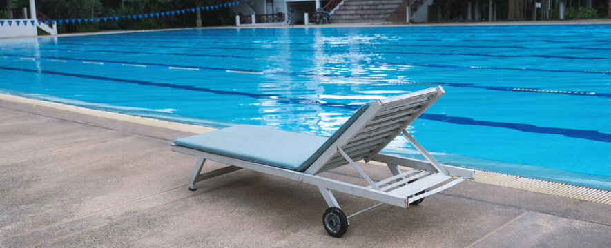 Picture of a sun bed chair on the edge of a hotel or resort swimming pool