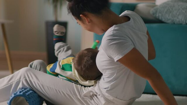 Mother playing with son during training at home