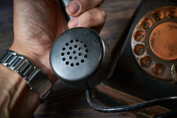 Classic telephone vintage color, dialing or scrolling phone on wooden table