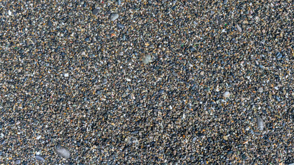 sea beach of small multi-colored pebbles as a natural background