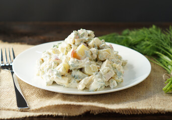 Traditional German potato salad with cucumber and mayonnaise.