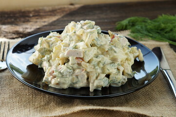Traditional German potato salad with cucumber and mayonnaise.