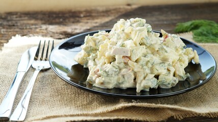 Traditional German potato salad with cucumber and mayonnaise.