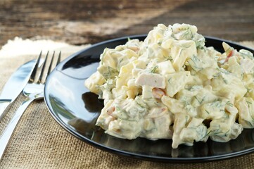 Traditional German potato salad with cucumber and mayonnaise.