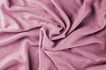 Close-up of bright yellow draped lightweight fabric as background. Selective focus.