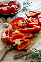 Fresh red peppers cut in halves on a board