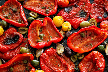 Roasted red pepper with capers, olives and herbs, close up view