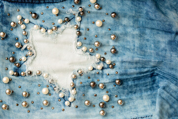 Jeans background clothing. Denim fabric closeup. Textures of clothing made of fabric with fashionable embroidery of pearl beads. Copy space for text. Fashionable style.