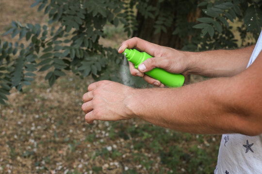 Mosquito repellent. Men using insect spray outdoors, insect bites,mosquito bite,itching of skin diseases,allergy,rashin outdoor park,ringworm,tinea problem,atopic dermatitis