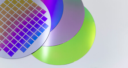 Several silicon wafers with printed circuit and different color.White background - obrazy, fototapety, plakaty