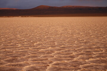 storm at salt flat desert on sunset