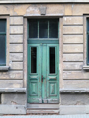 Fototapeta na wymiar Weathered wooden door in old ruin building