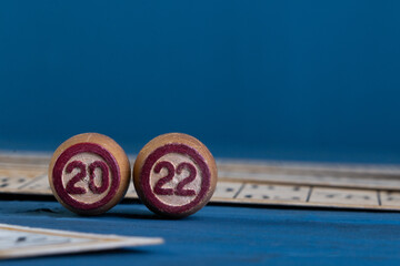 new Year's toys and numbers 2022 on the background of maps. the concept of the new year.A family board game of lotto. Cards and barrels with numbers. Play at home on a cold winter day.