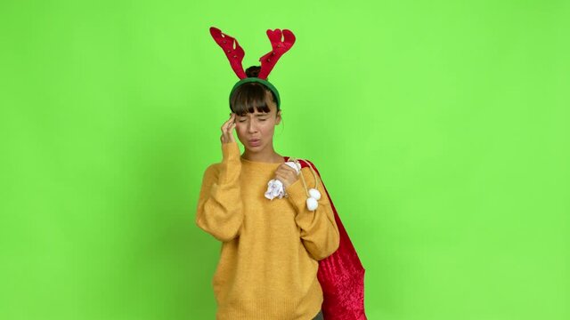Young woman with christmas hat unhappy and frustrated with something over isolated background. Green screen chroma key