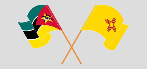 Crossed and waving flags of Mozambique and the State of New Mexico