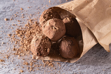 chocolate truffles in a paper bag, sprinkled with cocoa