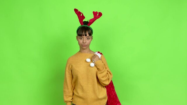 Young woman with christmas hat doing stop sign over isolated background. Green screen chroma key