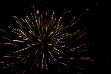 Salute in the sky. Explosion of fireworks in the night sky. Firecrackers flapping sparks in a dark space. Festive fireworks.