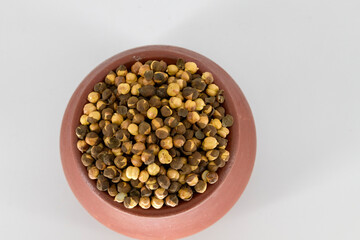 Selective focused Indian health snack called Varuth uppu kadalai , rosted chickpeas with salt on a isolated white background. Rosted without oil and very healthy daily snacks