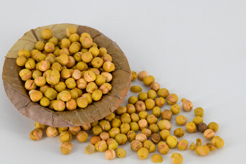 Selective focused Indian crispy salted fried and roasted green peas or peas. Also called pattani , isolated white background very healthy daily snacks in Tamilnadu, Kerala and Mumbai.