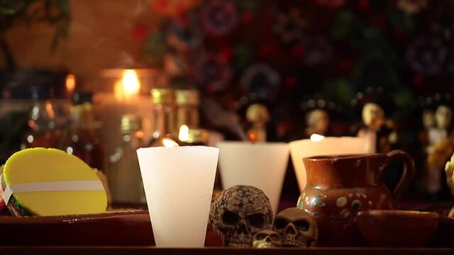 Smoking candle in traditional Mexican offering for Day of the Dead celebration in Mexico.