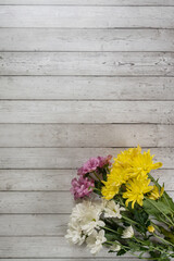 bouquet of colorful chrysanthemums on a wooden background